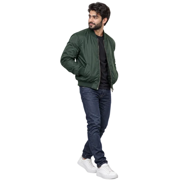 Man in a forest green bomber jacket, dark jeans and white sneakers
